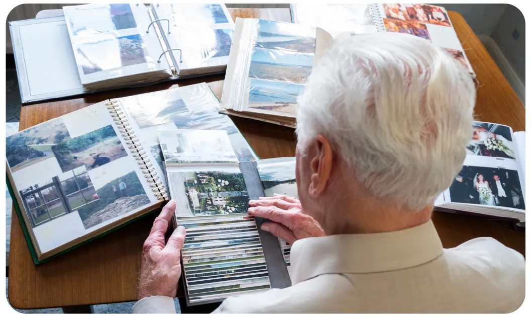 Senior man reviewing family photo albums